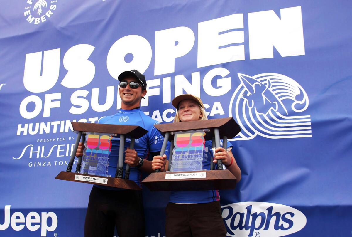 Griffin Colapinto of San Clemente, left, and Caitlin Simmers of Oceanside are all smiles as they hold their trophies Sunday.