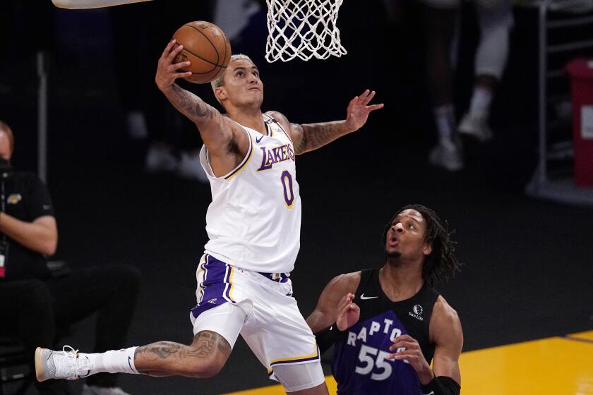 Los Angeles Lakers forward Kyle Kuzma, left, shoots as Toronto Raptors forward Freddie Gillespie defends during the first half of an NBA basketball game Sunday, May 2, 2021, in Los Angeles. (AP Photo/Mark J. Terrill)