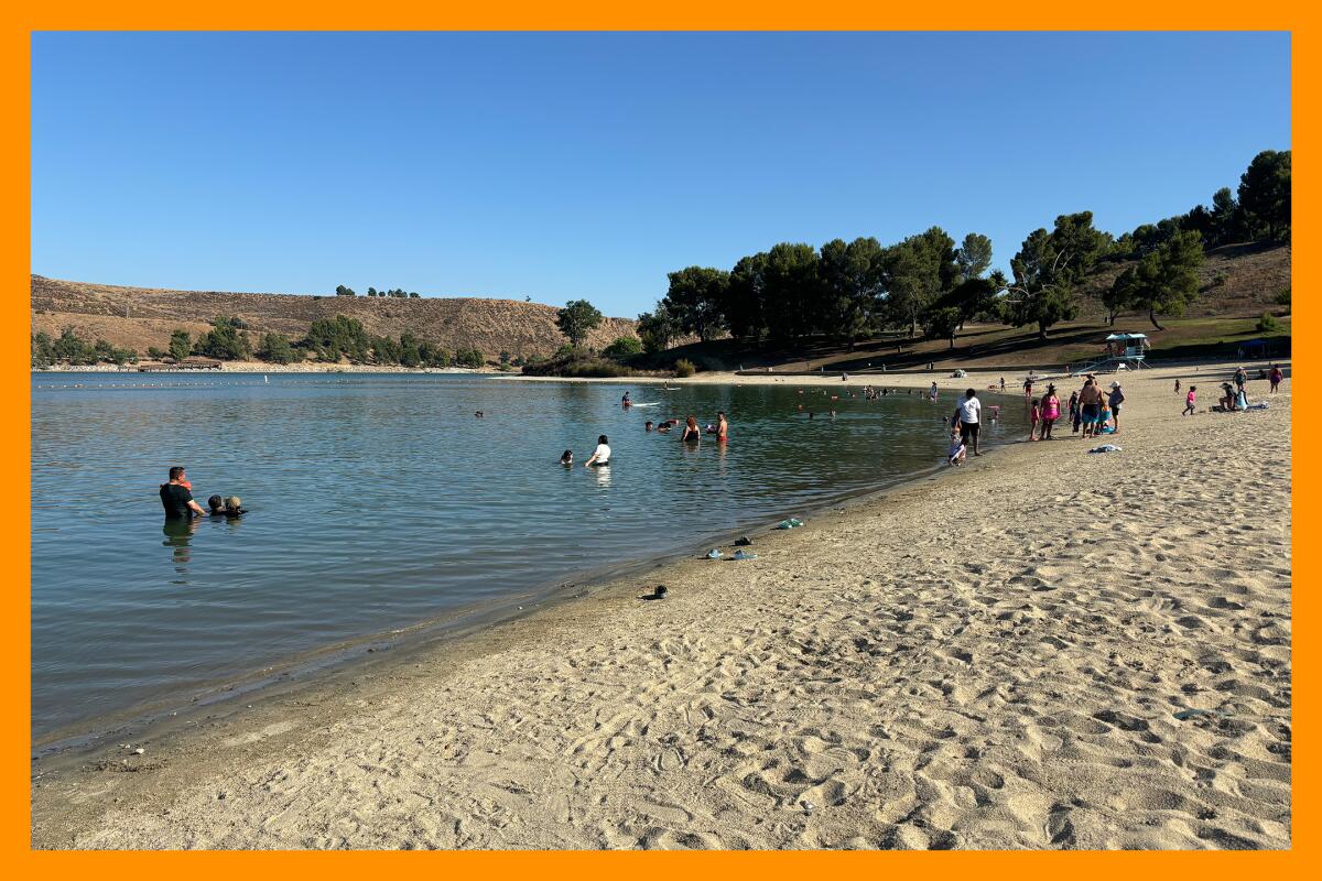 Beachgoers enjoy cooling off at the Castaic Lake swim area.