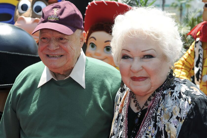 FILE - Estelle Harris, at right, and Don Rickles arrive at the world premiere of "Toy Story 3," Sunday, June 13, 2010, at The El Capitan Theater in Los Angeles. Harris, who hollered her way into TV history as George Costanza’s short-fused mother on TV’s “Seinfeld” and voiced Mrs. Potato Head in the “Toy Story” franchise, has died. She was 93. Harris’ agent Michael Eisenstadt confirmed the actor’s death in Palm Desert, Calif., late Saturday, April 2, 2022. (AP Photo/Katy Winn, File)