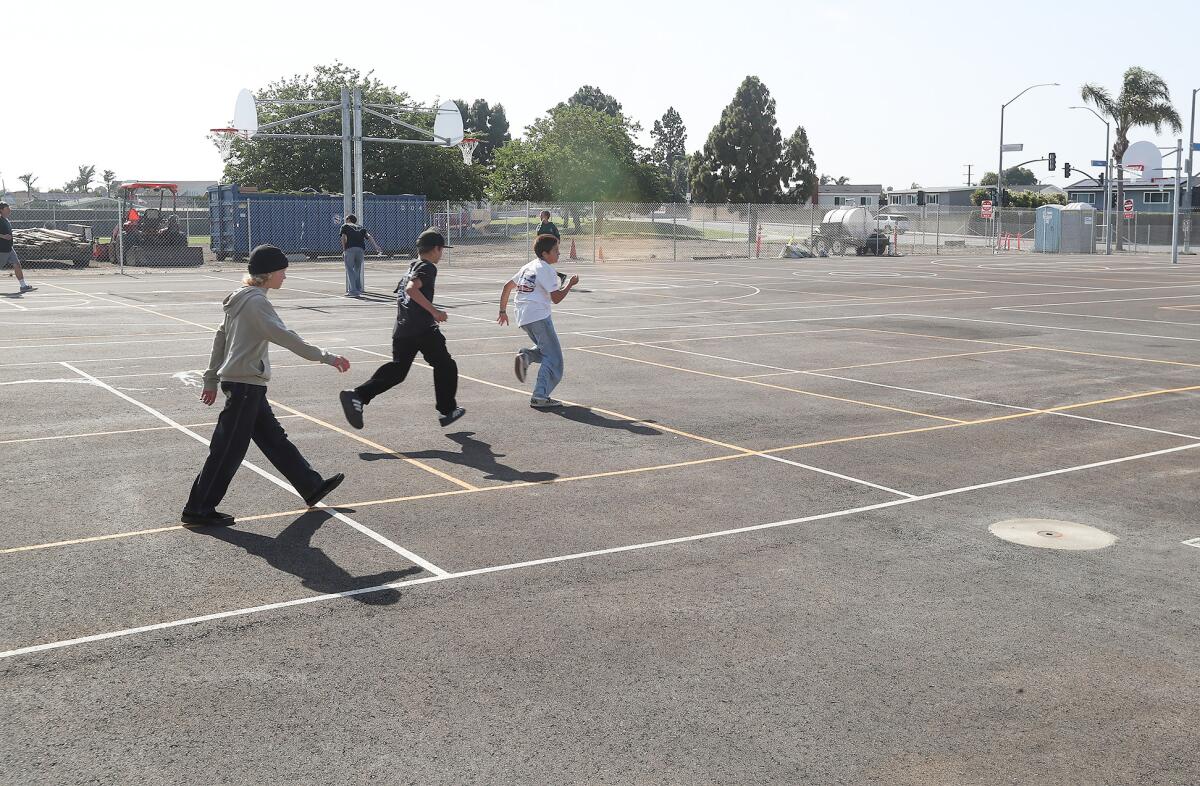 Students run across the new hardscape sports courts at Sowers Middle School in Huntington Beach on Wednesday.