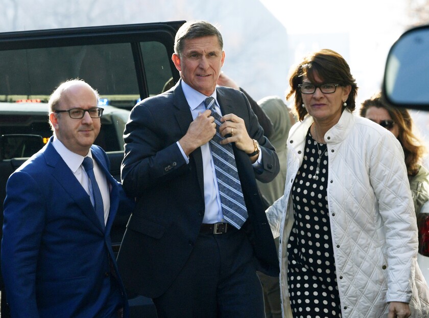 FILE - In this Dec. 1, 2017, file photo, Michael Flynn, center, arrives at federal court in Washington. (AP Photo/Susan Walsh, File)