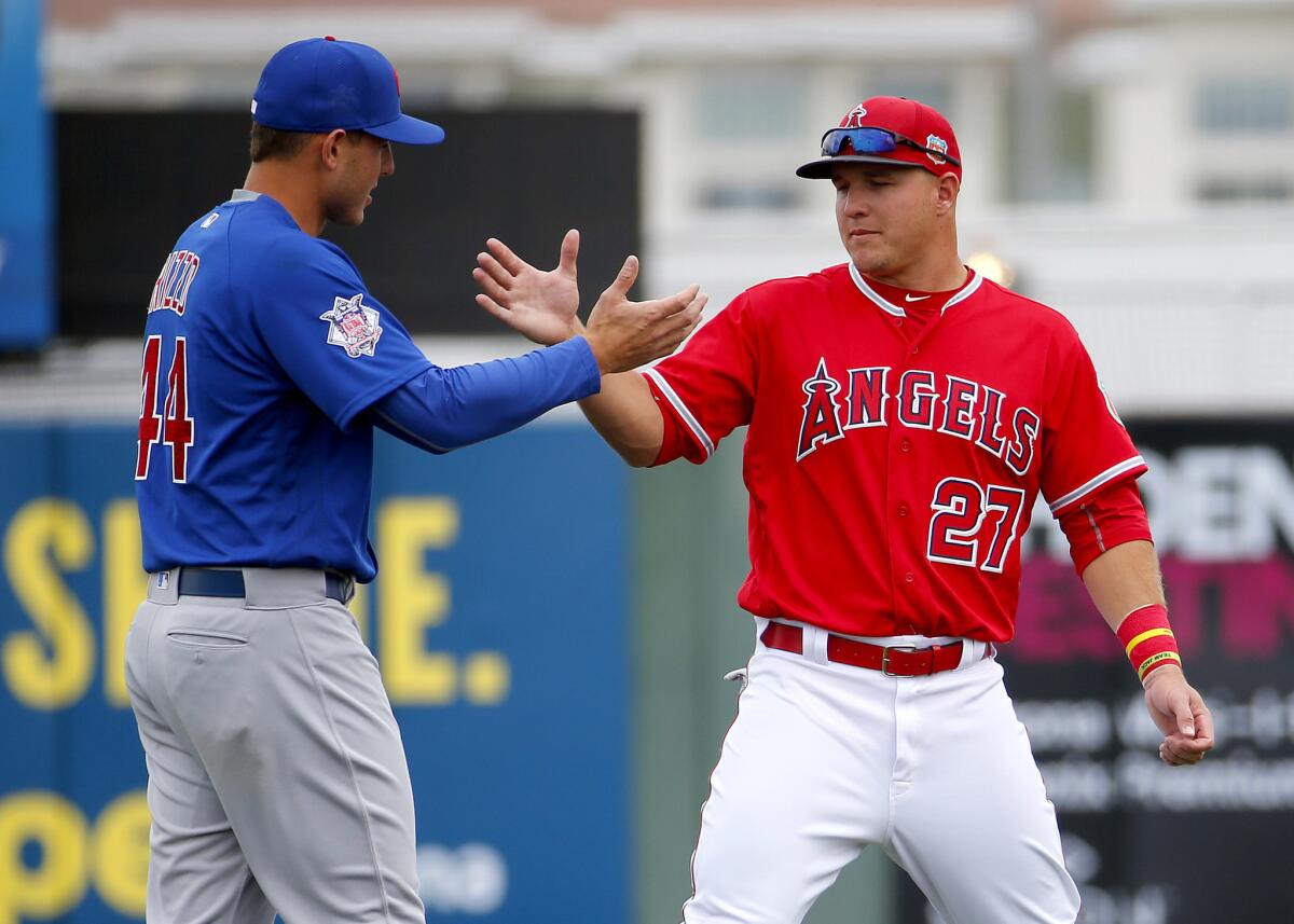 Angels outfielder Mike Trout (27) greets Cubs first baseman Anthony Rizzo prior to a spring training game.