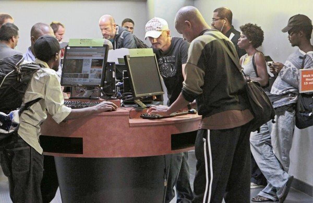 People wait in line for 15 minutes for a computer at the Central Library.