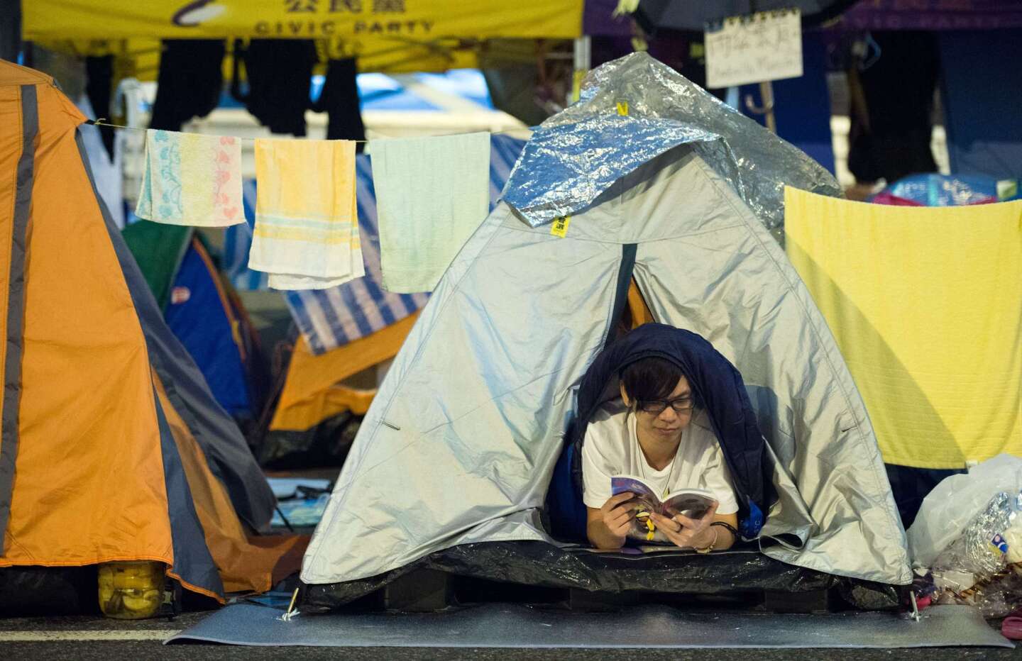 A student reads a book in his tent at the pro-democracy movement's main protest site in the Admiralty district of Hong Kong on Dec. 2.
