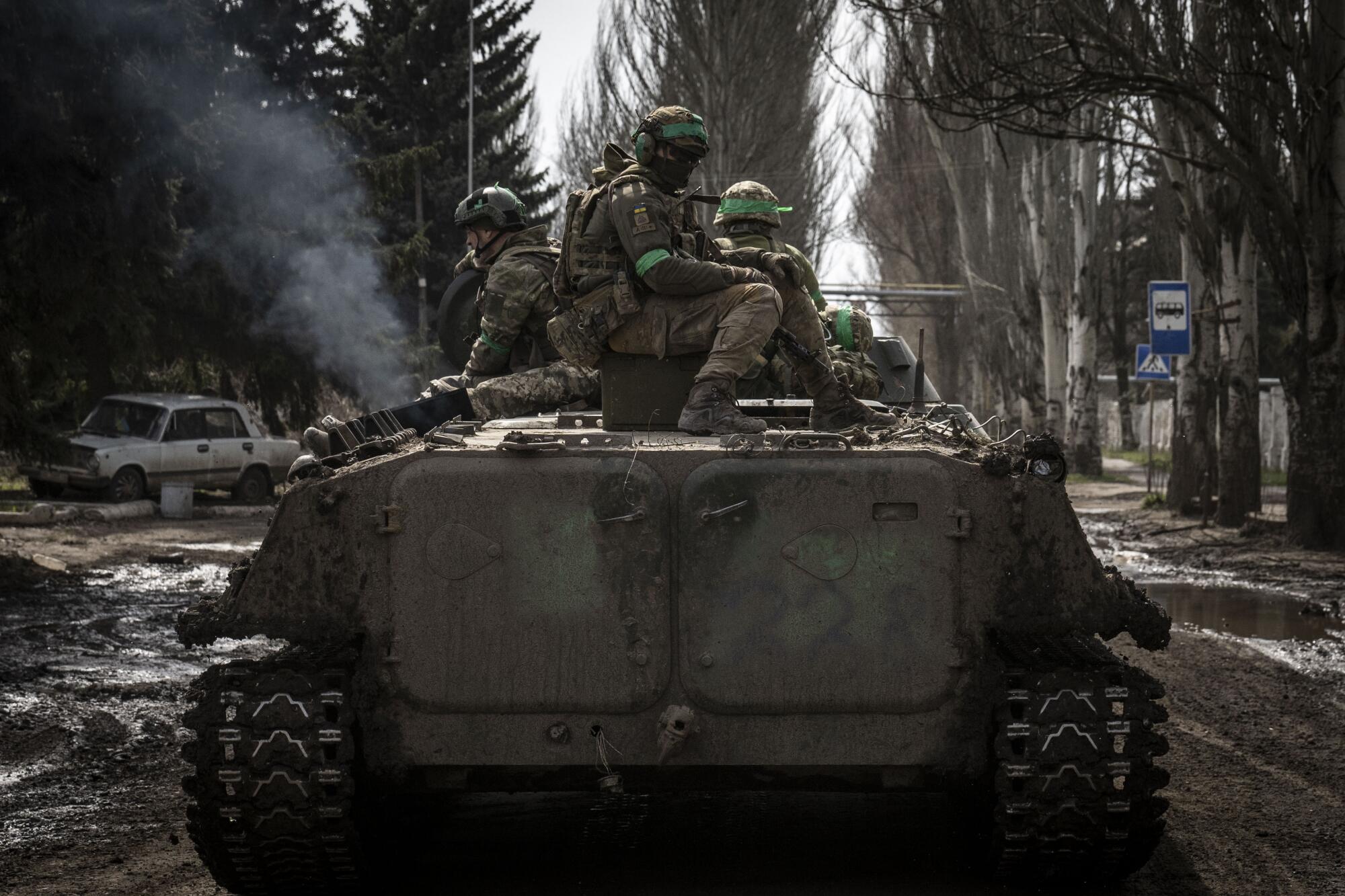 Ukrainian soldiers riding a tank