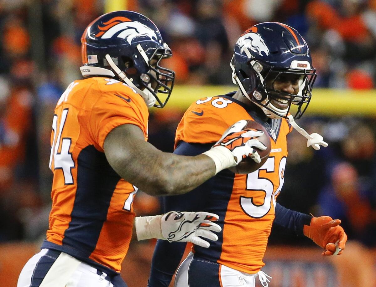 Broncos linebacker DeMarcus Ware, left, celebrates after recoveing a fumble with fellow linebacker Von Miller during a divisional playoff game against the Steelers on Jan. 17.