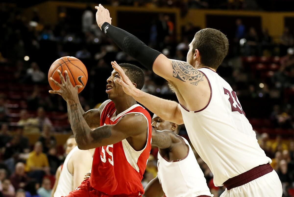 Utah's Delon Wright (55) drives past Arizona State's Eric Jacobsen during the first half of their Pac-12 game Thursday night.