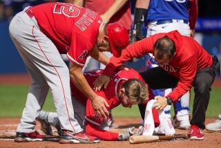 TORONTO, ON - JULY 29: Taylor Ward #3 of the Los Angeles Angels is helped after being hit by a pitch.