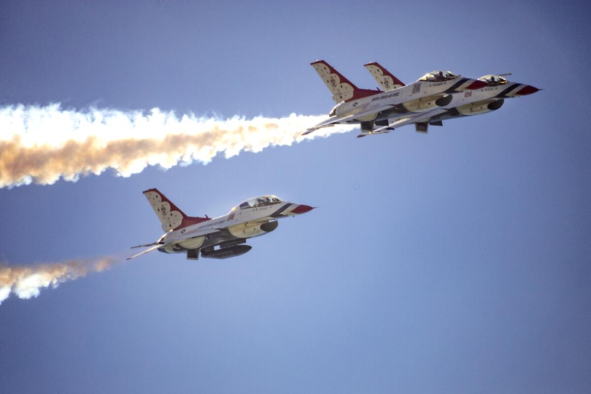 The U.S. Air Force Thunderbirds fly in formation over Huntington Beach Pier at the Pacific Airshow in 2021.