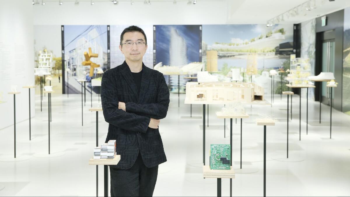 Sou Fujimoto stands amid architectural models and his three-dimensional design sketches at Japan House Los Angeles.