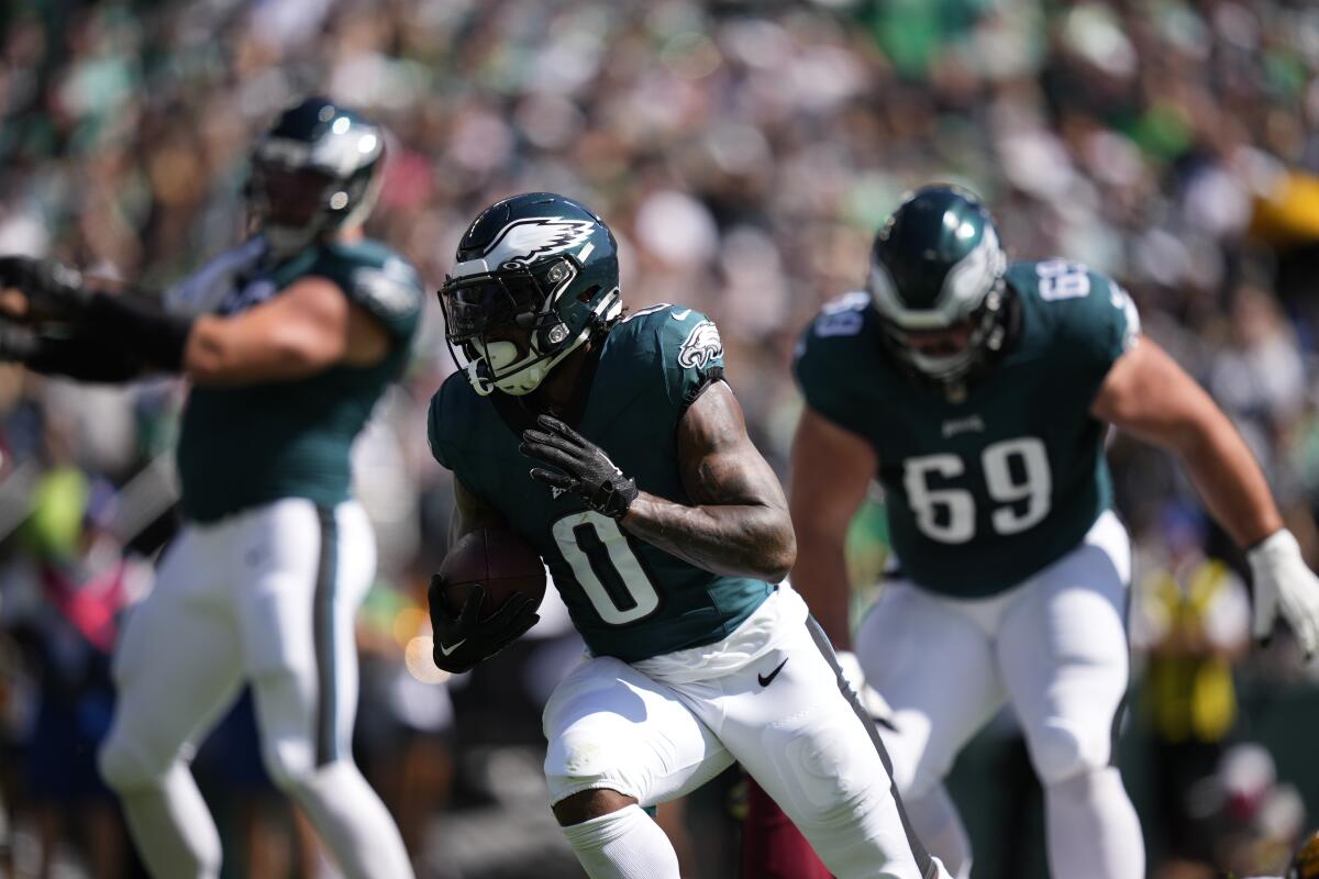 The Eagles' D'Andre Swift runs against the Commanders.