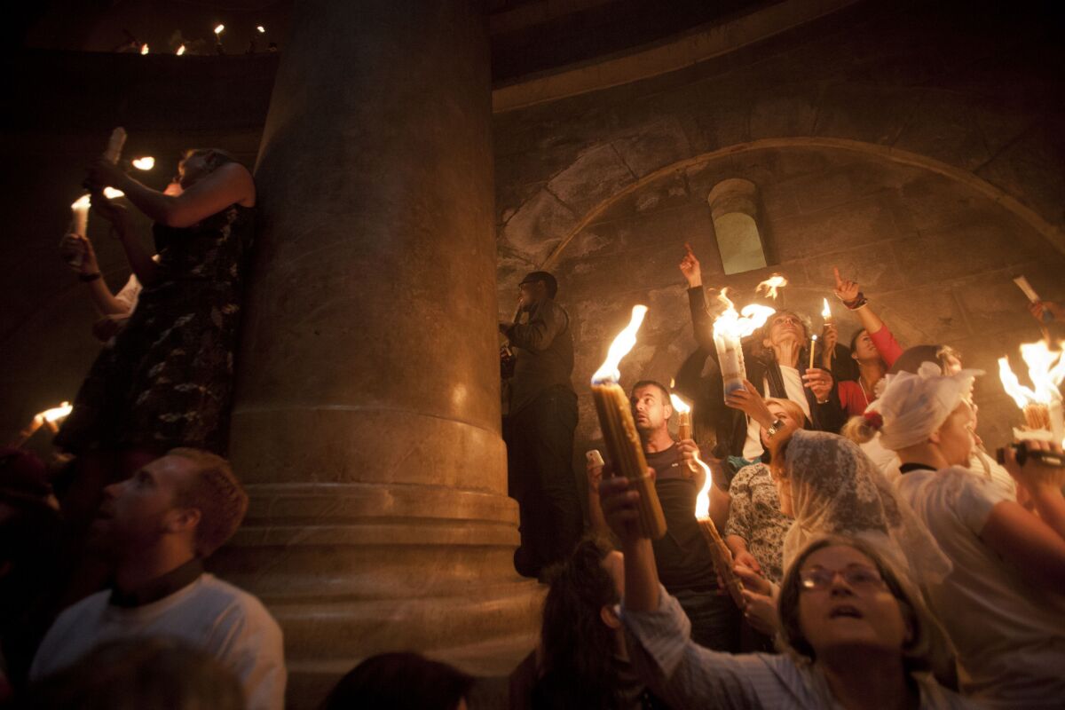 Christian pilgrims hold candles at the Church of the Holy Sepulcher, believed to be the burial site of Jesus Christ, during the ceremony of the "holy fire" in Jerusalem's Old City on Saturday.