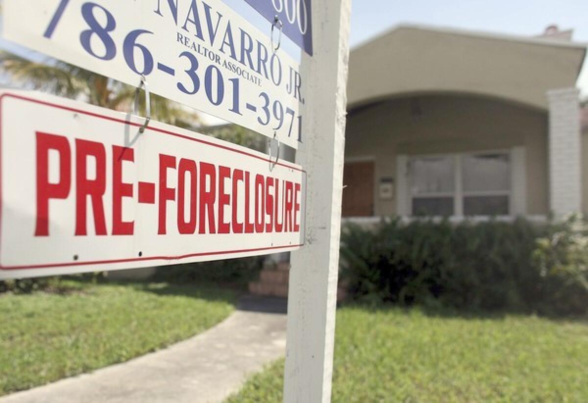 A home with a pre-foreclosure sale sign