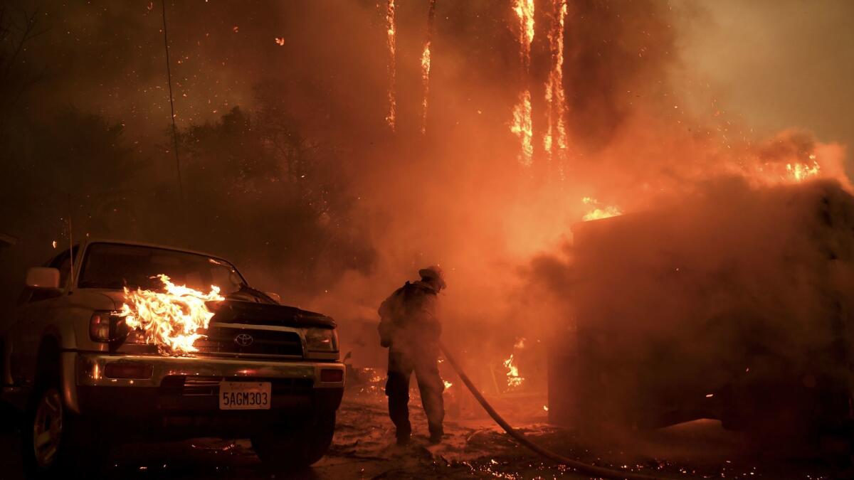 A firefighter battles the Thomas fire along Highway 33 in Casita Springs in Ventura County.