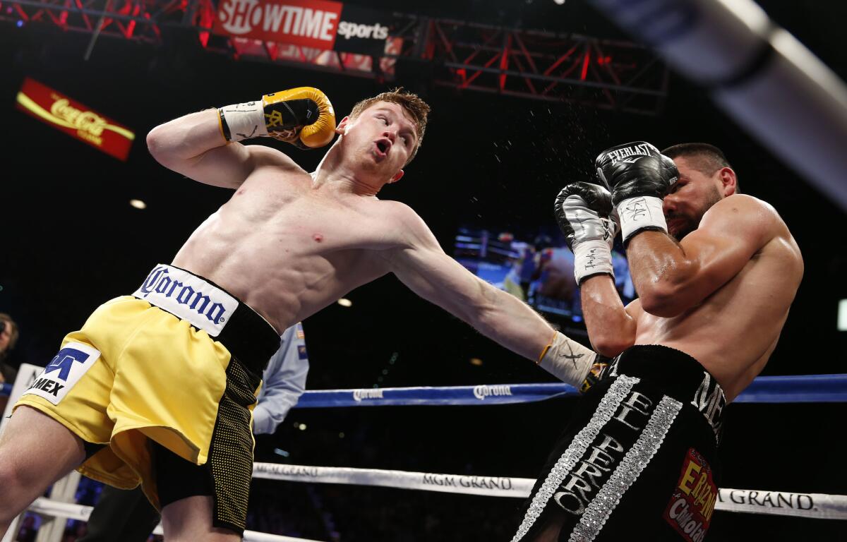 Saul "Canelo" Alvarez, left, trades punches with Alfredo Angulo during their super welterweight match on March 8.