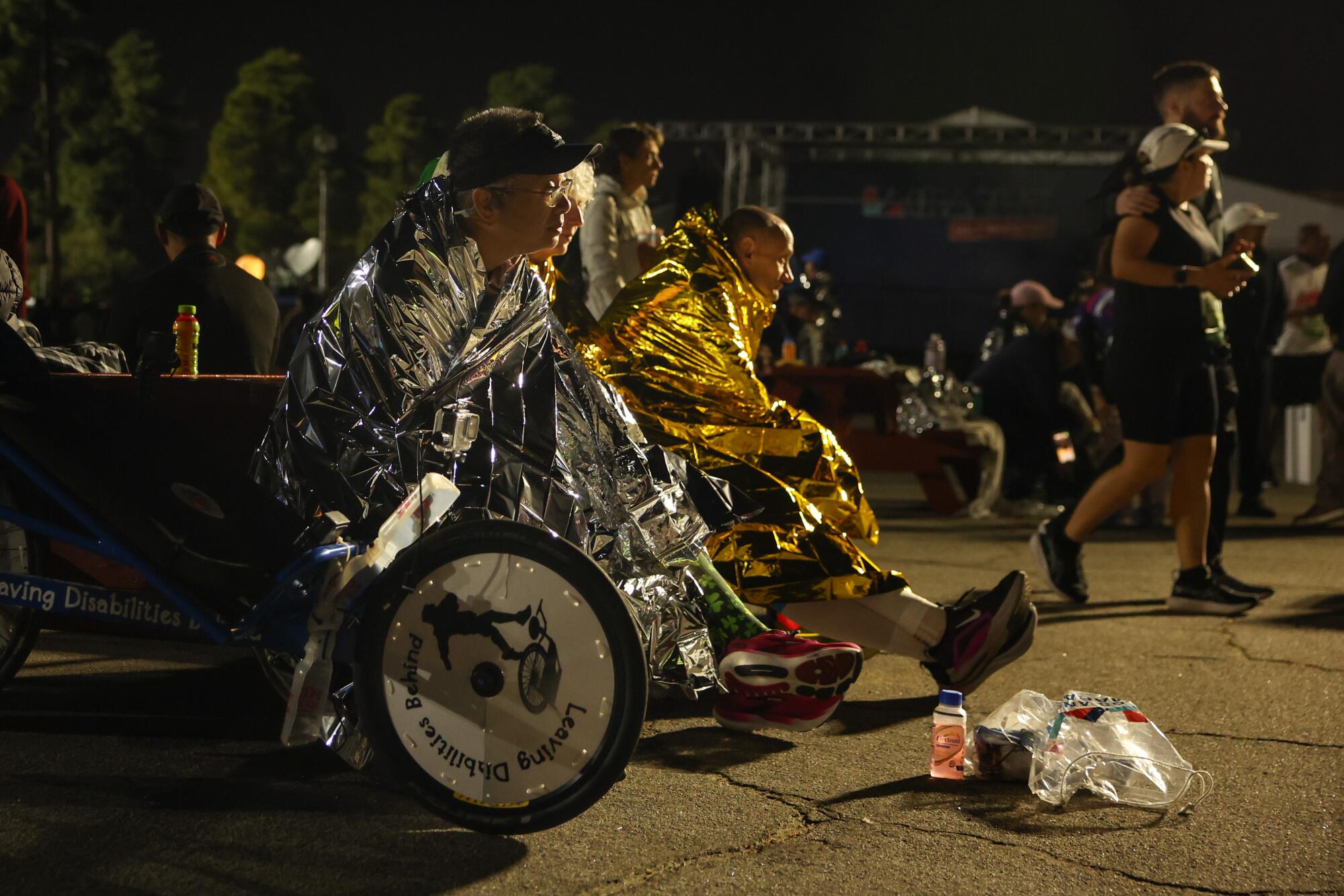 Ericson Orlanes keeps warm in mylar blanket before the start of the 39th Los Angeles Marathon.