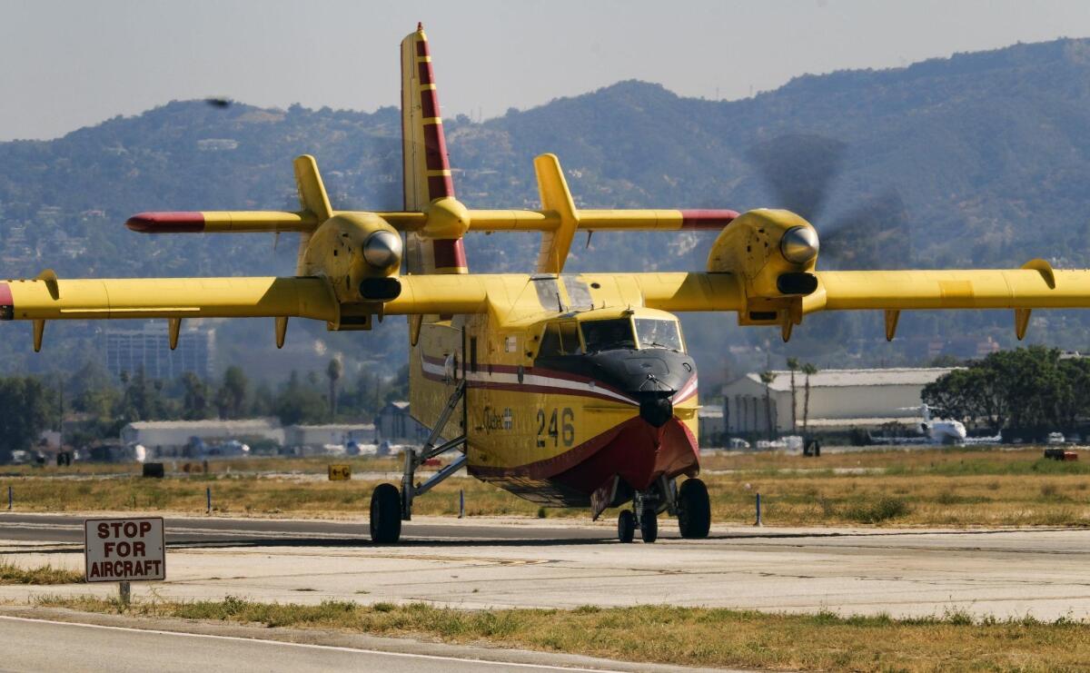 One of two "super scooper" firefighting aircraft arrive arrive on lease from Quebec at the Van Nuys airport in Los Angeles on Saturday. The large water tankers, which can carry up to 1,600 gallons of water, arrived nearly a month earlier than usual.