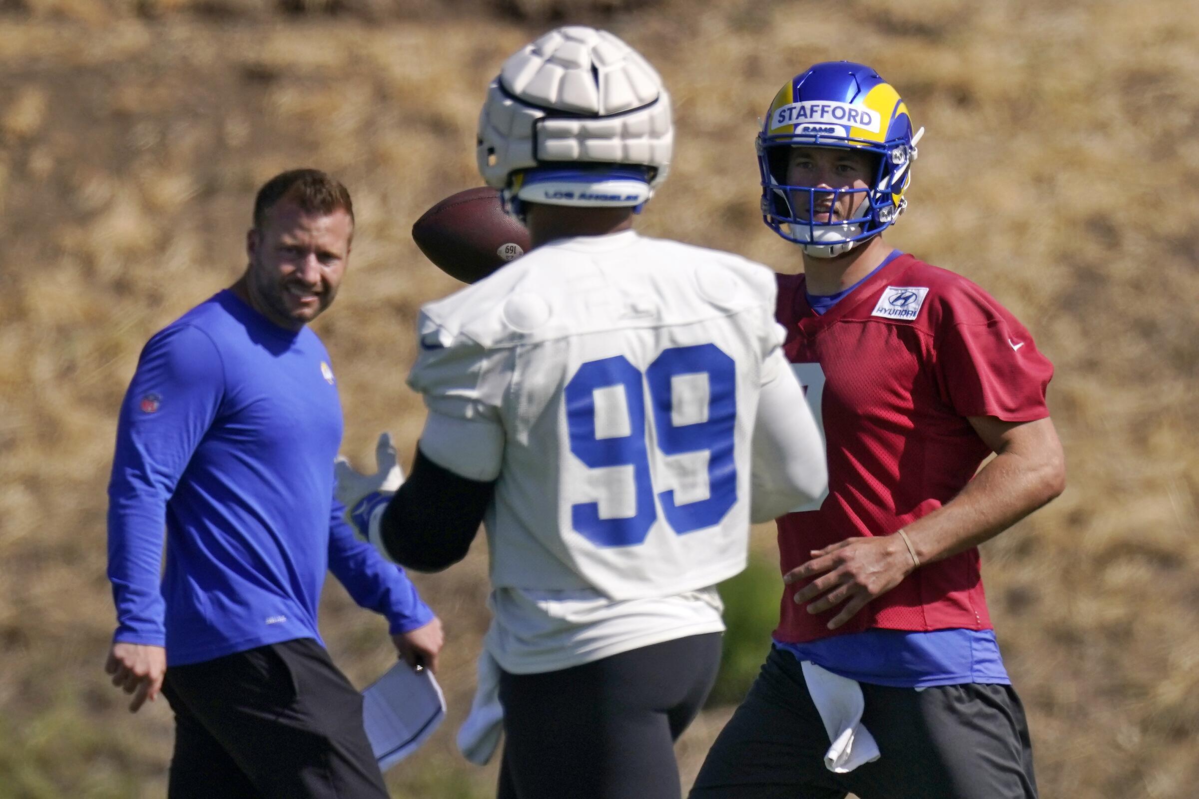 Rams quarterback Matthew Stafford fakes a pass in front of Aaron Donald and Sean McVay.