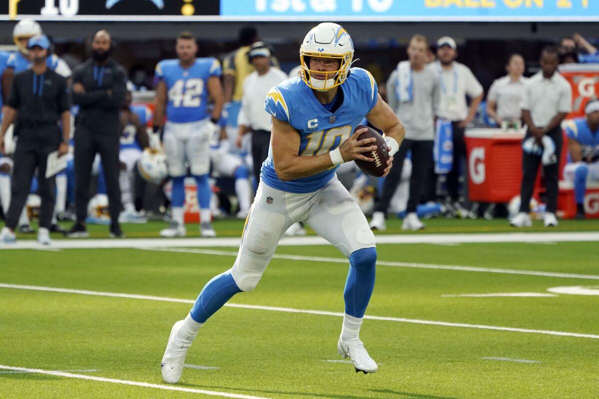 Chargers quarterback Justin Herbert rolls out during a loss to the Jacksonville Jaguars on Sept. 25.