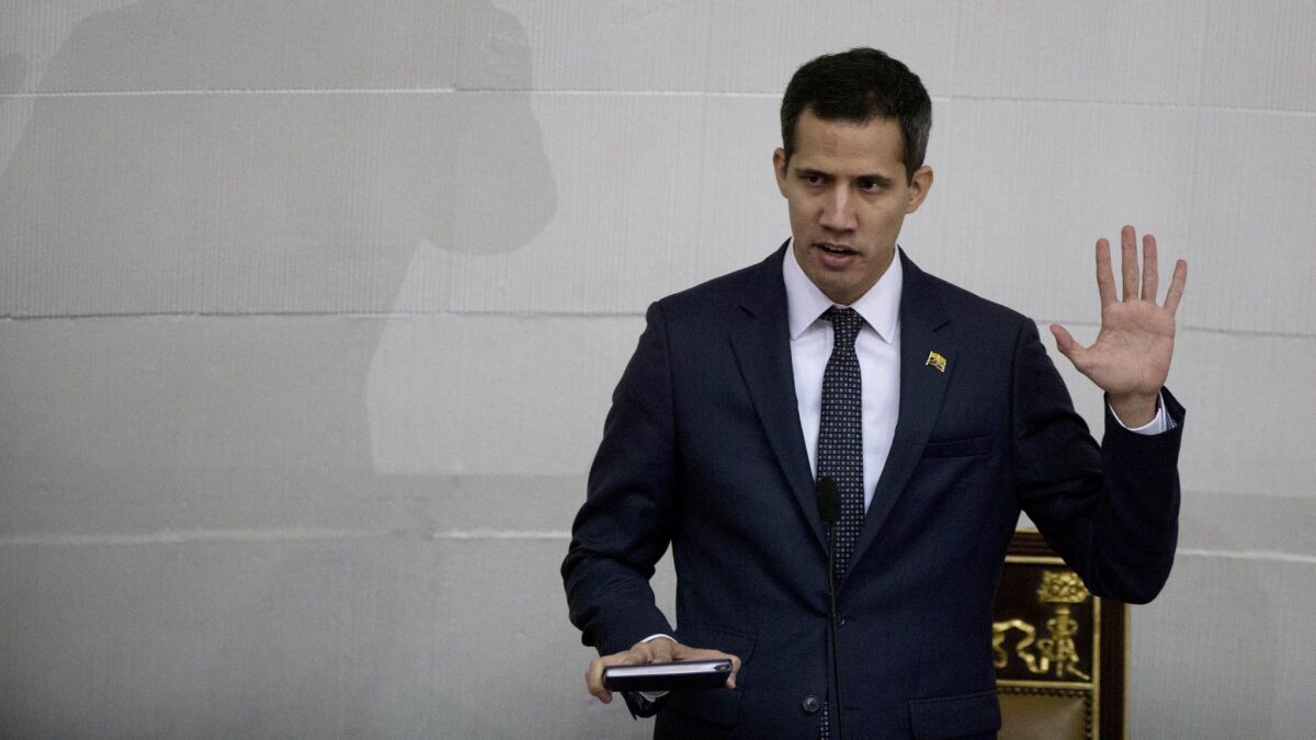 Venezuelan lawmaker Juan Guaido takes the oath of office as the new president of the National Assembly in Caracas on Saturday.