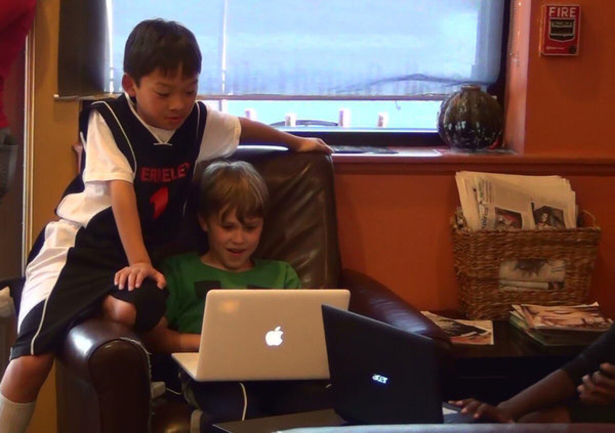 Kyle Kuwahara, left, and Jude Kratzer are among a group of Berkeley fourth-graders who use the video game Minecraft to stay in touch with classmate Rodrigo Guzman, 10, who was deported along with his family to Mexico.