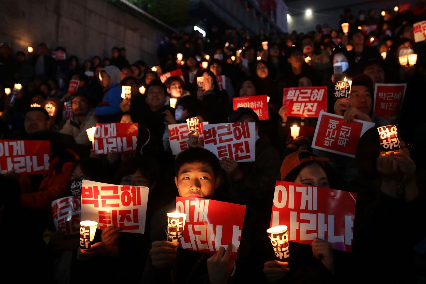 Thousands of South Koreans take to the streets in Seoul to demand that President Park Geun-hye step down.