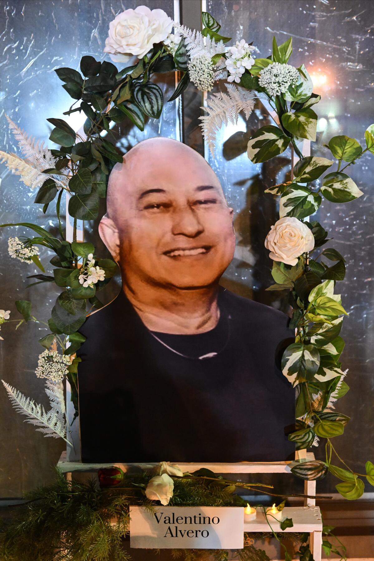 A portrait of Valentino Marcos Alvero sits on display in front of the dance studio.