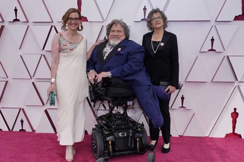 Nicole Newnham, left, James LeBrecht and Sara Bolder arrive at the 2021 Oscars at Union Station in Los Angeles