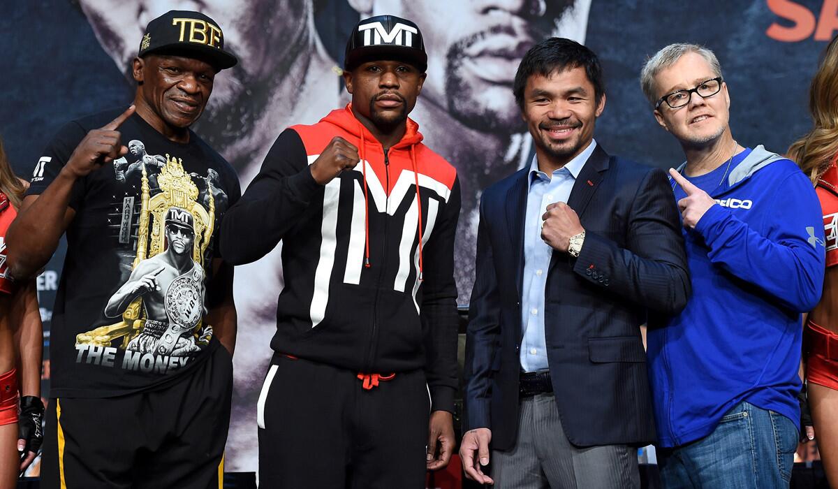 From left to right, trainer Floyd Mayweather Sr., Floyd Mayweather Jr., Manny Pacquiao and trainer Freddie Roach pose during a news conference in Las Vegas on April 29.