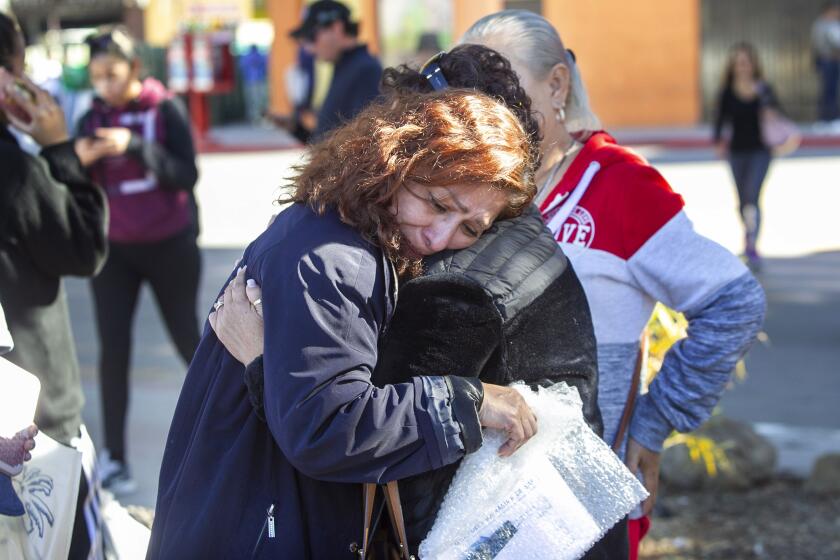 Rocio Rebollar Gomez, whose immigration case has attracted international attention partly because her son is a 2nd. Lt in the US Army, was consoled by her compadre Miriam Cruz, right, outside of the El Chapparal port of entry in Mexico after being deported with only her passport, cell phone and the clothes on her back.on Thursday January 2, 2020.