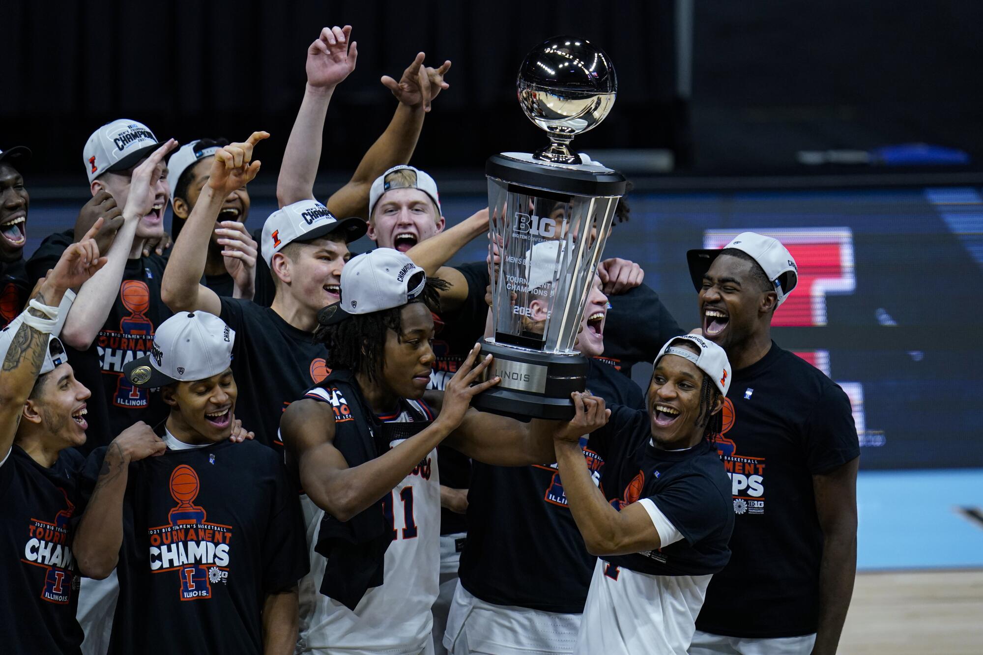 Illinois players celebrate after defeating Ohio State 91-88 in overtime to win the Big Ten tournament title Sunday.