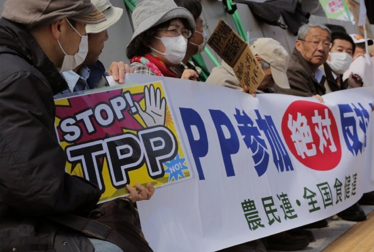 Farmers protest against the Trans-Pacific Partnership in Tokyo. Their banner reads: "We absolutely oppose Japan's participation to TPP."