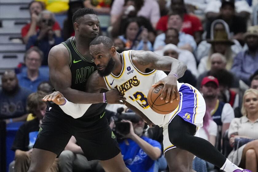 Los Angeles Lakers forward LeBron James drives to the basket against New Orleans Pelicans forward Zion Williamson in the second half of an NBA basketball game in New Orleans, Sunday, April 14, 2024. The Lakers won 124-108. (AP Photo/Gerald Herbert)