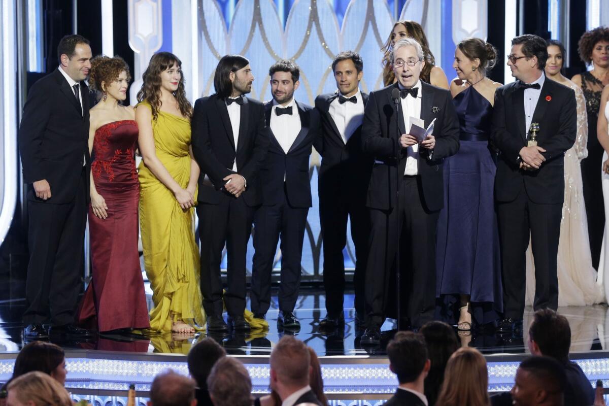"Mozart in the Jungle" executive producer Paul Weitz accepts the award for TV comedy series at the Golden Globe Awards. Among those joining him onstage are, second from left moving right, cast members Bernadette Peters, Lola Kirke and Jason Schwartzman.