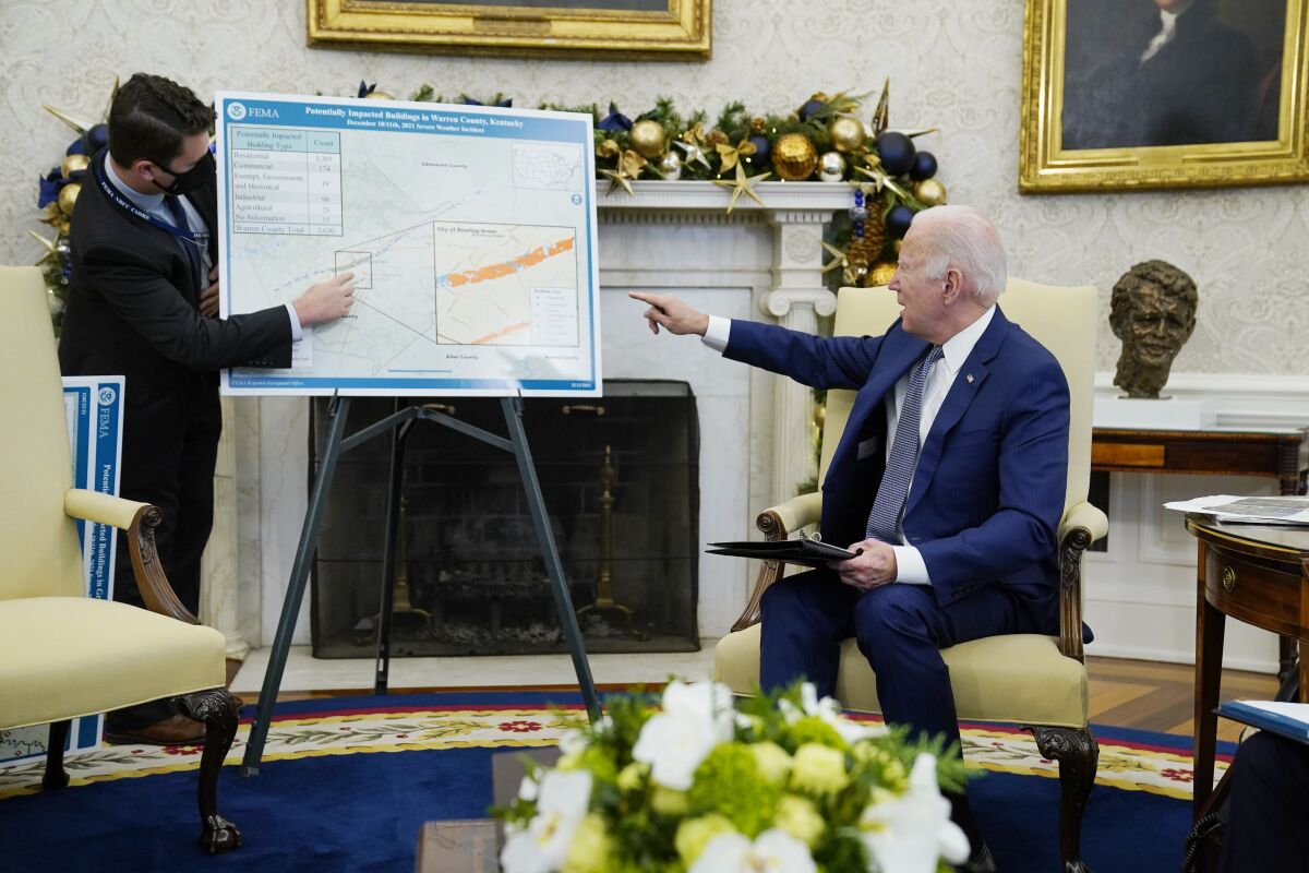 President Joe Biden participates in a briefing on the federal response to tornado damage, in the Oval Office of the White House, Monday, Dec. 13, 2021, in Washington. (AP Photo/Evan Vucci)