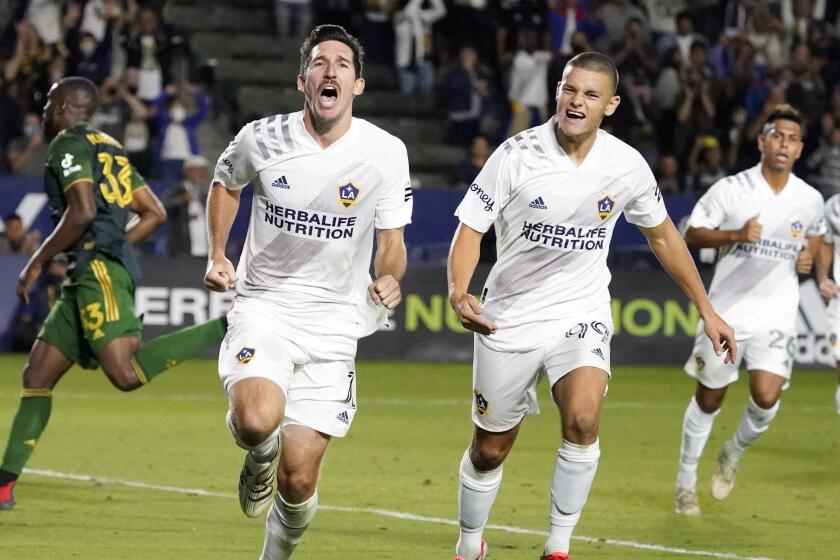 LA Galaxy midfielder Sacha Kljestan, center, celebrates after scoring on a penalty kick.