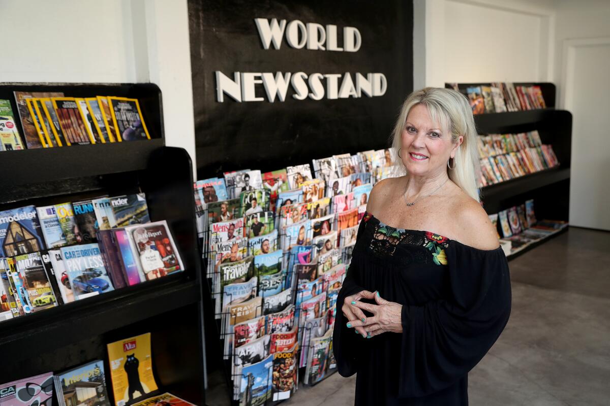 Owner Heidi Miller stands inside the World Newsstand's new location on Saturday at 687 S. Coast Highway in Laguna Beach.