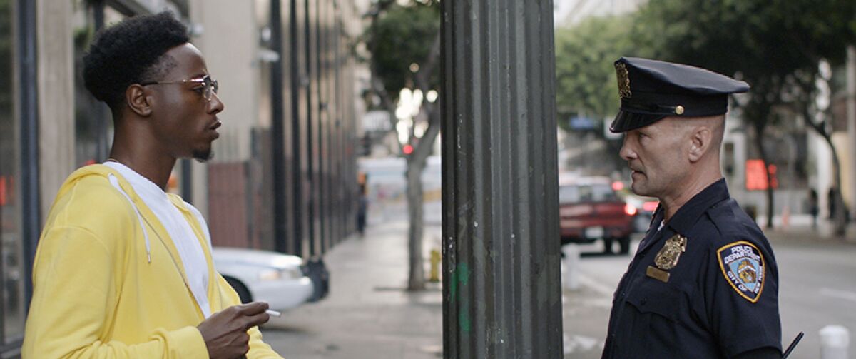 Joey Badass faces Andrew Howard on a city sidewalk in "Two Distant Strangers."