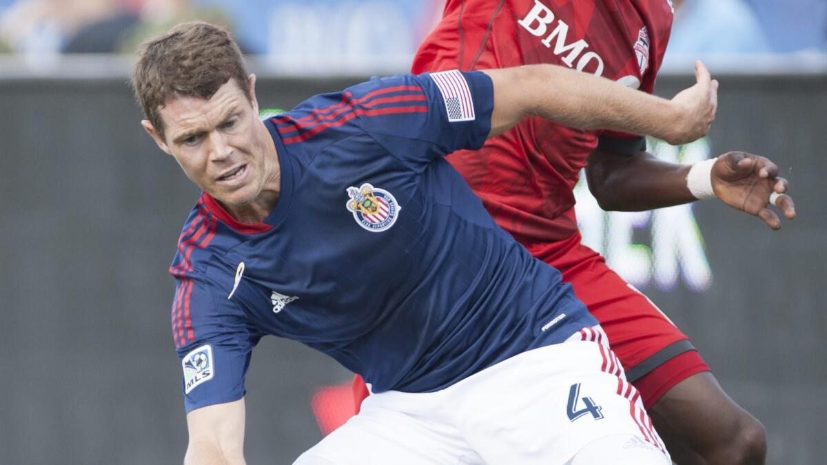 Chivas USA's Tony Lochhead defends against a Toronto FC player during a match on Sept. 21.