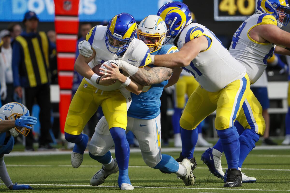 Chargers defensive end Morgan Fox sacks Rams quarterback Baker Mayfield in the first half.