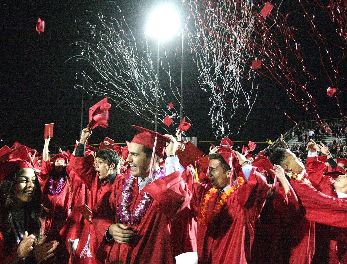 Cannons with confetti shoot into the air mixed with tossed graduation caps at the conclusion of the graduation ceremony of Burroughs High School's class of 2016 on the school's football field on Thursday, May 26, 2016.
