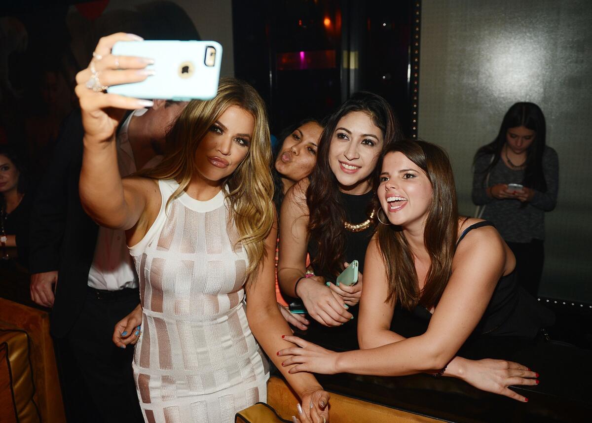 Khloe Kardashian takes a photo with fans at 1 OAK Nightclub at the Mirage on Friday night.