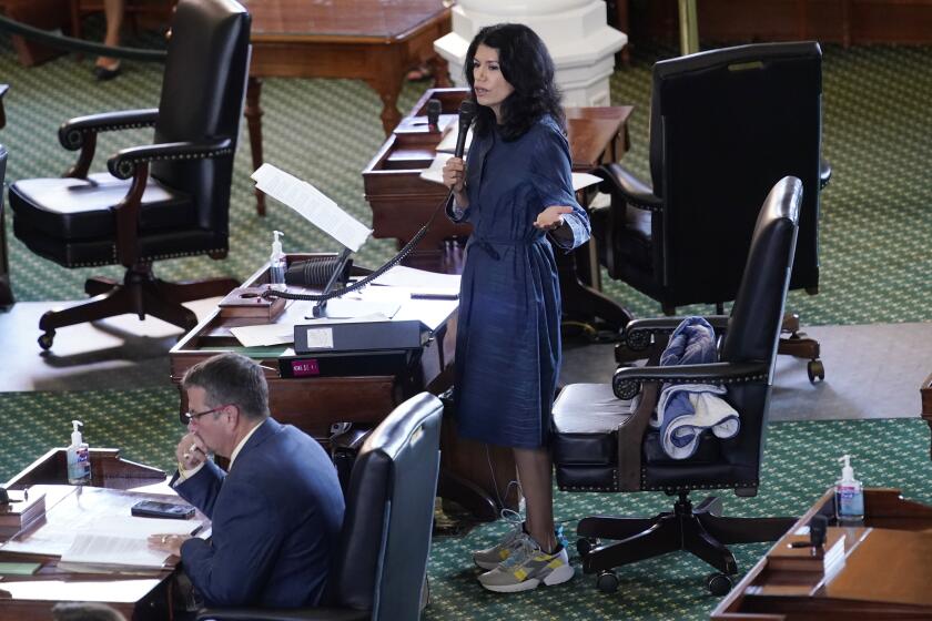 Texas State Sen. Carol Alvarado, D-Houston, wears running shoes as she filibusters Senate Bill 1, a voting bill.