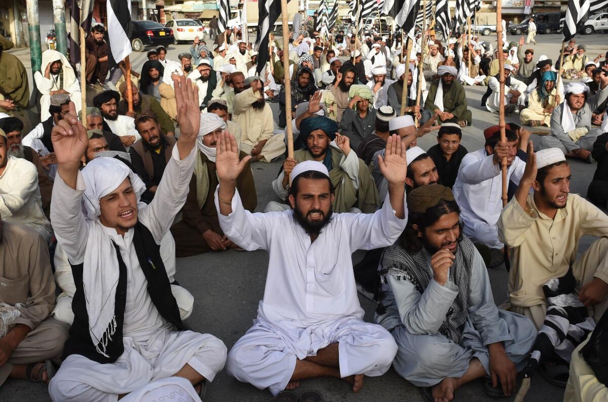 Pakistani members of the Jamiat Nazriati party pay tribute to Afghanistan's deceased Taliban chief Mullah Mohammed Omar, in Quetta, Pakistan, on Sunday.