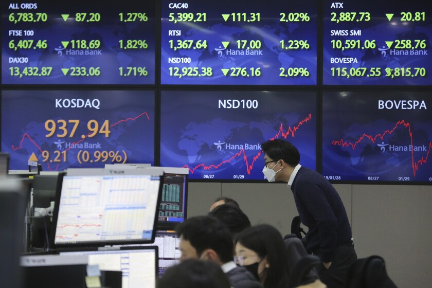 A currency trader watches monitors in Seoul