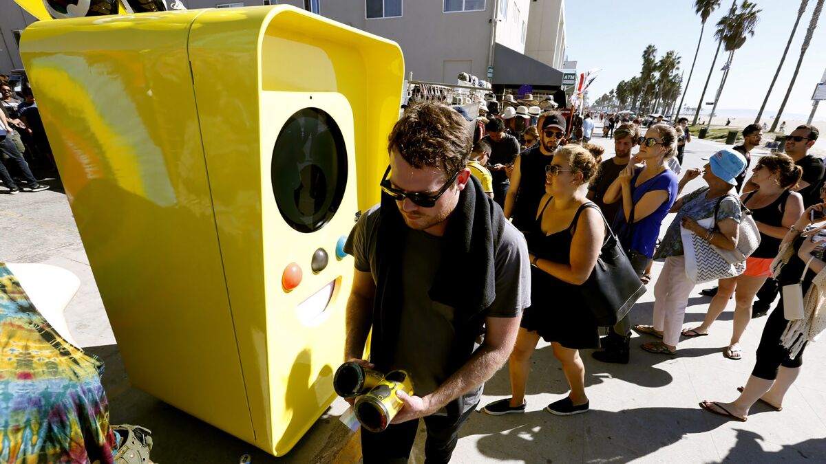 Snapchat Spectacles are dispensed from a bright yellow vending machine on the Venice Beach boardwalk Thursday.