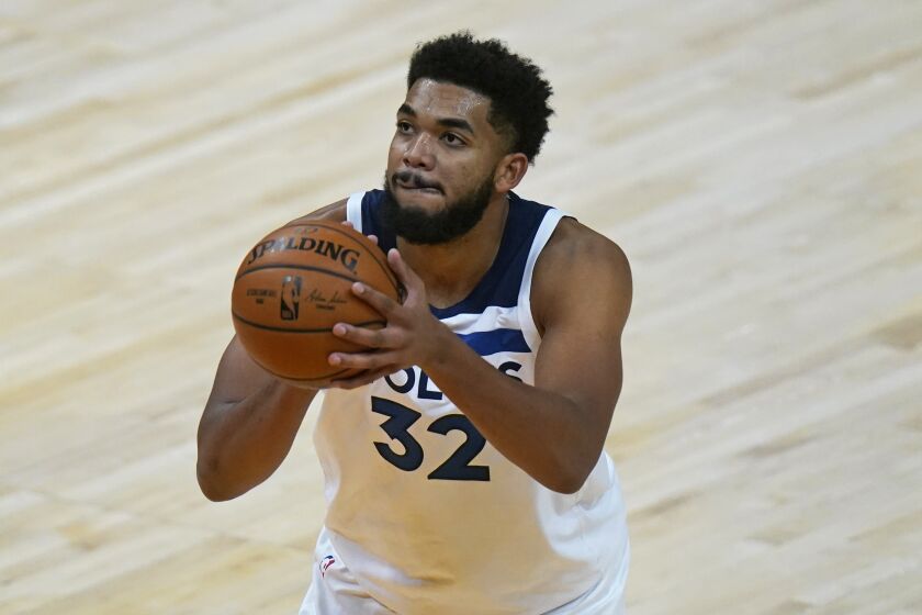 Minnesota Timberwolves center Karl-Anthony Towns (32) shoots a foul shot during the second half of an NBA basketball game against the Utah Jazz Saturday, Dec. 26, 2020, in Salt Lake City. (AP Photo/Rick Bowmer)