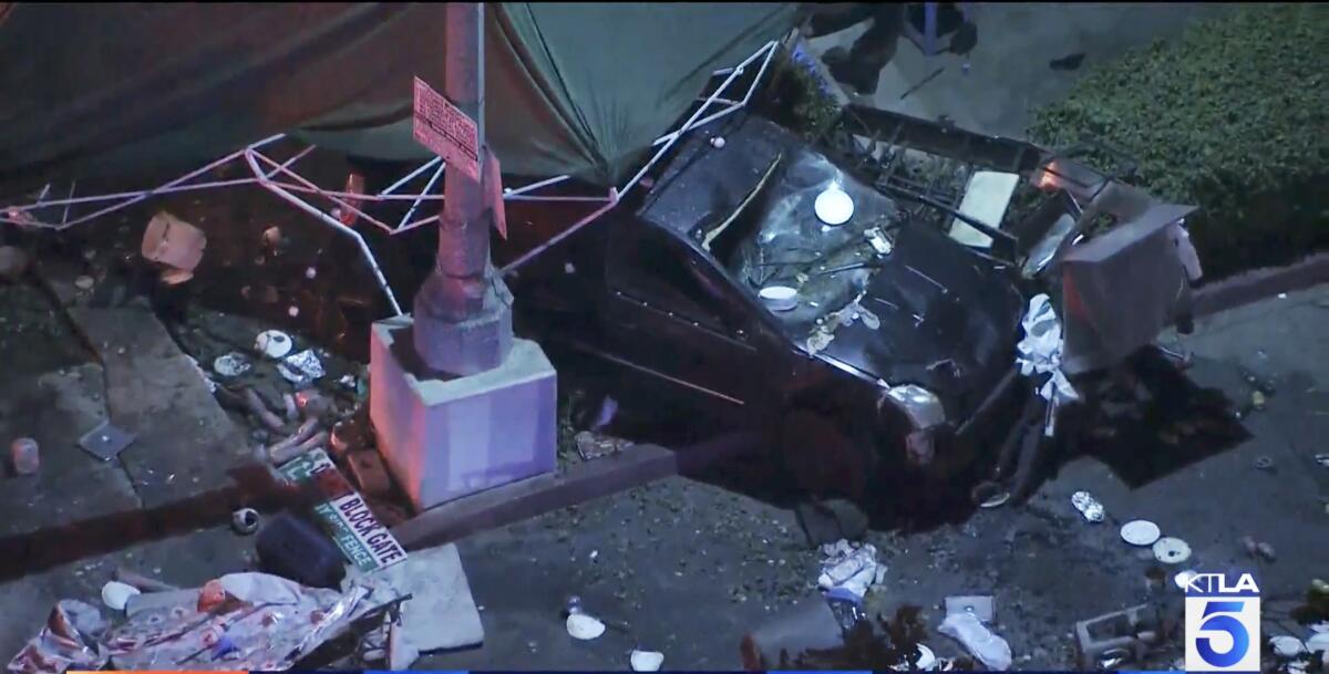 The scene of a car crash at a food vendor's canopy 