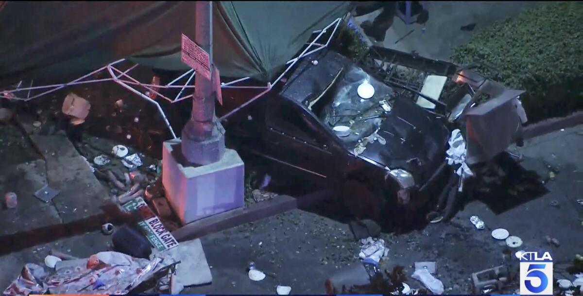 The scene of a car crash at a food vendor's canopy